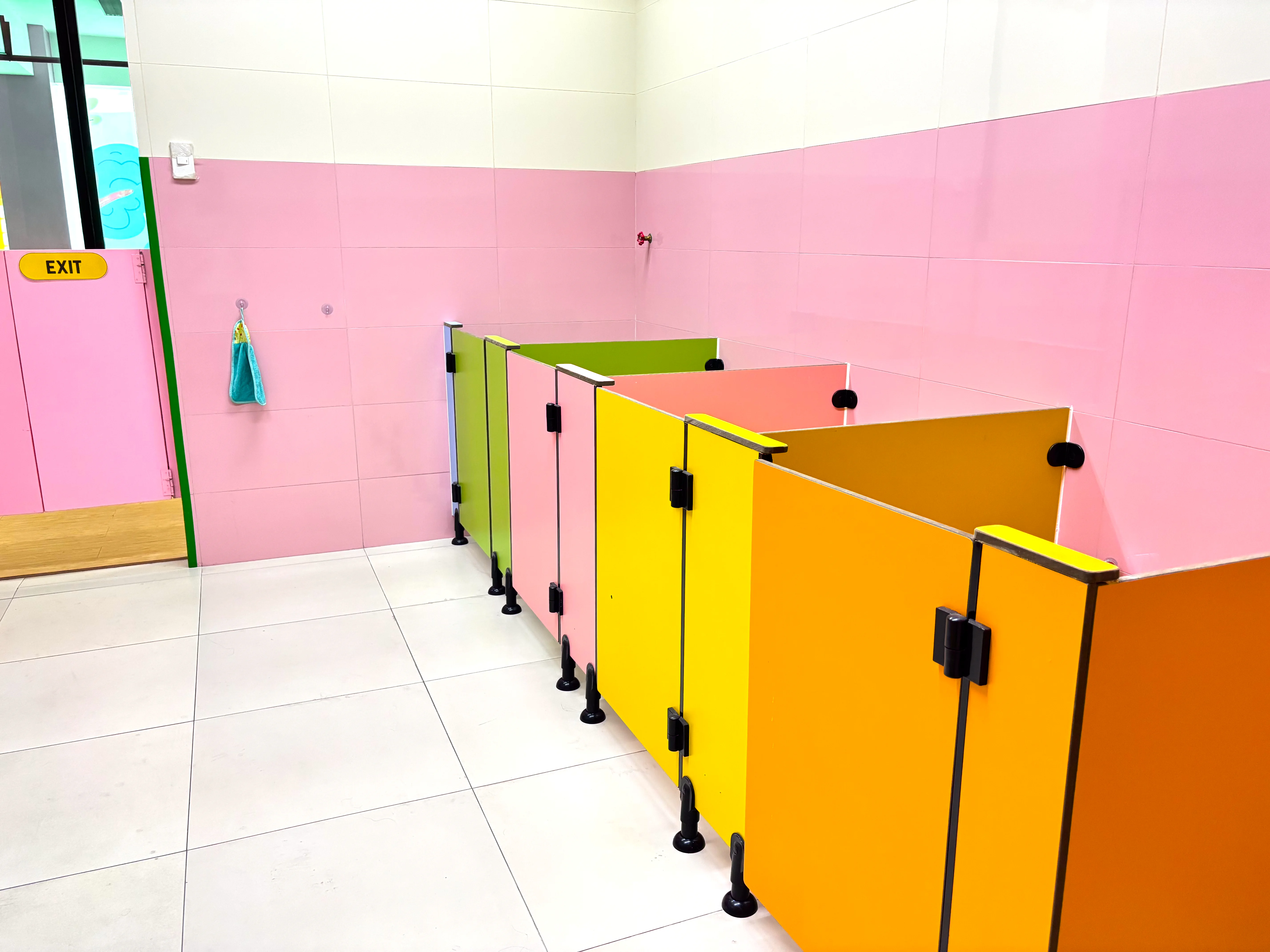 Girls comfort room with clean, colorful child-sized stalls